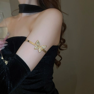 Close-up of sparkling butterfly upper arm cuff with rhinestones on a woman's arm