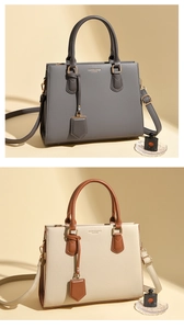 Close-up of litchi texture leather handbags in dark grey and beige with metal charms