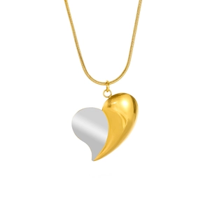 Close-up of heart pendant with two-tone gold and silver finish on a snake chain