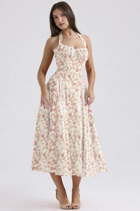 Detailed close-up of white floral print sundress with halter neck and corset waist