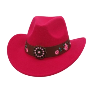 Detail of fuchsia wool felt cowboy hat featuring floral embroidery and a bronze metal ornament