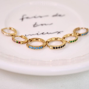 Detailed display of colorful gemstone micro-pave 14K gold-plated huggie hoop earrings