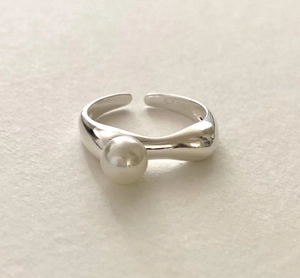Macro shot of S925 sterling silver ring featuring a lustrous white pearl accent