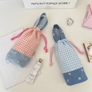 Top view of patchwork plaid cup pouches with pink drawstring closure and star prints