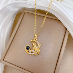 Elegant gold unicorn moon necklace with sparkling crystals and a projection stone