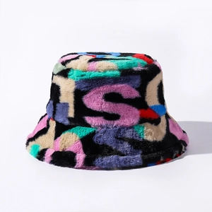 Close-up of colorful faux fur bucket hat featuring soft texture and purple letter S pattern