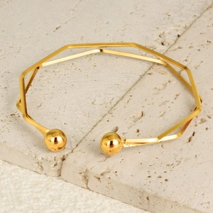 Detail of 18K gold-plated stainless steel open bracelet with geometric octagon design