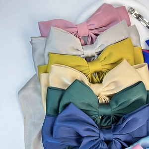 Gros plan de barrettes à nœuds en satin élégants de plusieurs couleurs pour cheveux