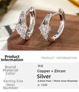 Macro detail of silver star hoop earrings with white zircons and 10mm inner diameter