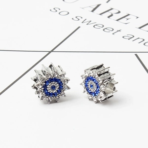 Macro shot of silver sun flower bead with blue and white zircon for DIY bracelets