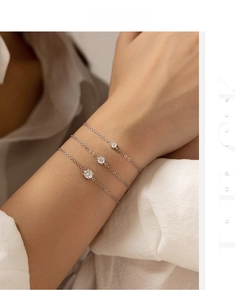 Close-up of S925 silver bracelet featuring three round-cut moissanite stones on a slim chain