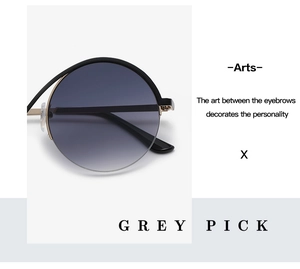 Detail view of semi-rimless sunglasses with grey gradient lenses and metal temples