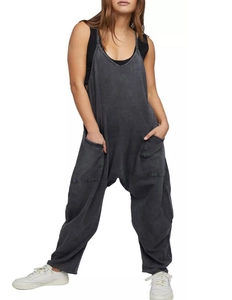 Detail of dark grey oversized overalls with large side pockets and relaxed harem fit