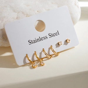 Set of 3 pairs golden stainless steel earrings with crystal rhinestones on white card