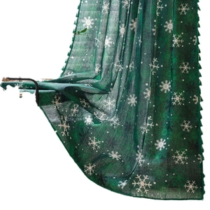 Green Christmas curtain with white snowflake patterns and elegant fringe details