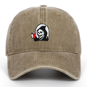 Close-up of Grim Reaper embroidery on vintage khaki washed cotton baseball cap