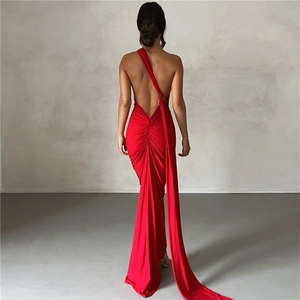 Detail of red backless evening dress with elegant ruching and long trailing fishtail hem