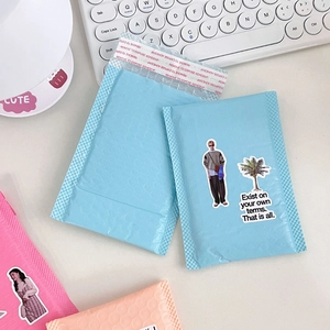 Detail of pink and blue bubble mailers with self-adhesive seals and protective padding