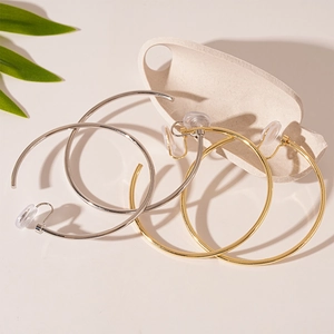 Minimalist gold and silver geometric hoop clip-on earrings with comfort pads
