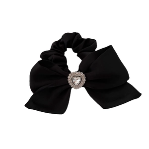 Elegant black silk bow scrunchie with rhinestone heart detail on white background