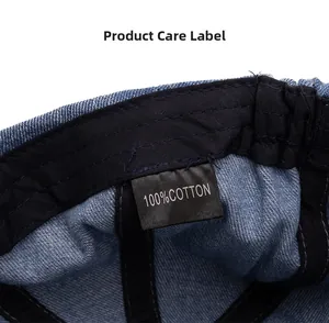 Detail shot of the care label inside the washed denim cap showing 100% cotton material