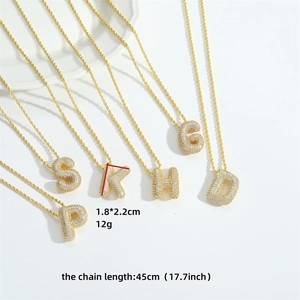 Gold letter pendant necklace with sparkling cubic zirconia on a minimalist chain