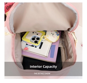 Pink school backpack showing spacious interior capacity with books and accessories