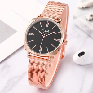 Macro shot of rose gold Milanese mesh band and black dial with rhinestone markers