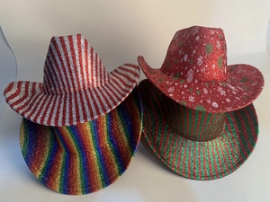Macro view showing 4 sequined party cowboy hats with festive stripes and snowflakes