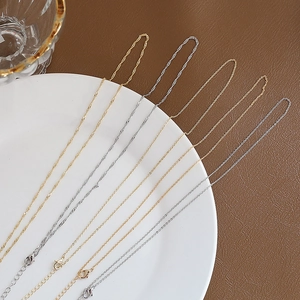 Detail of 14k gold plated and silver adjustable flat O-chains with lobster clasps
