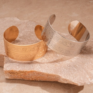 Ethnic style embossed wide open cuff bracelets in gold and silver metal with intricate patterns