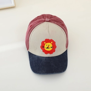 Detail of color-block kids baseball cap with yellow lion print and vintage washed fabric