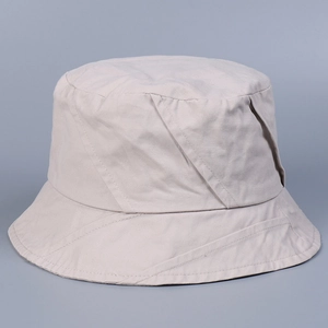 Detail of light beige washed cotton bucket hat showing soft fabric texture and twill stitching