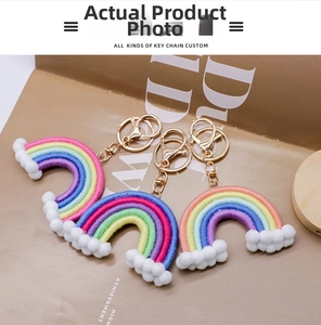 Detailed view of handmade woven rainbow keychains with colorful cotton rope and pompom balls