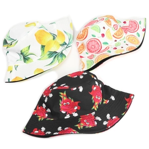 Detail view of tropical fruit prints on reversible bucket hats featuring lemon and strawberry