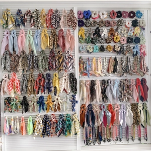Detailed display of assorted fruit and floral pattern scrunchies on a professional rack