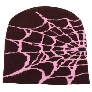 Detail of pink spider web jacquard pattern on a brown knit beanie for streetwear