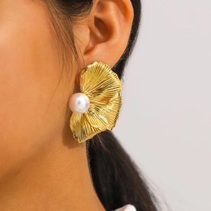 Elegant gold petal statement earrings with pearls shown on a model for a stylish vintage look