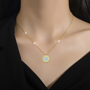 Minimalist gold titanium steel necklace with a round heart-shaped pendant on model