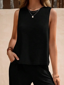 Detail showing the textured black sleeveless crewneck vest and minimalist fabric grain