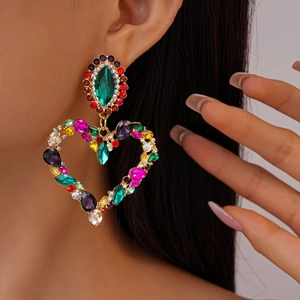 Macro view of colorful heart-shaped drop earrings with vibrant multi-color rhinestones