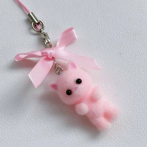 Close-up of pink flocked kitten charm with ribbon bow and silver metal hardware