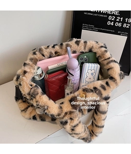 Spacious interior of leopard print plush tote bag showing daily essentials and soft faux fur