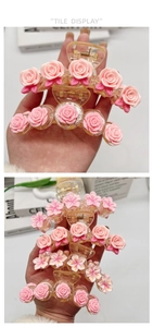 Detailed view of pink rose and cherry blossom hair claws with transparent resin clips