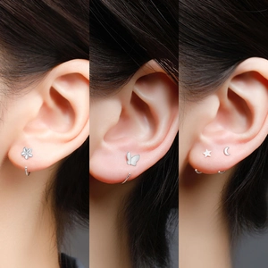 Detail showing 999 sterling silver stud earrings in flower, butterfly and moon shapes