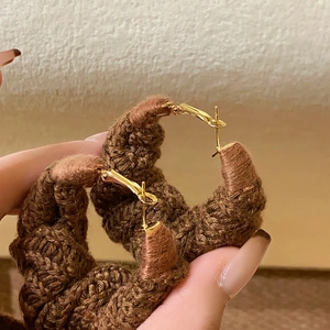 Vintage brown hand-woven wool circle earrings with gold needle clasp in a chic style