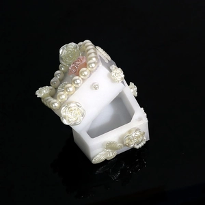 Detailed view of DIY resin jewelry box mold with white pearls and pink rose decorations