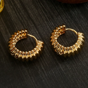 18K gold plated twisted hoop earrings with retro texture on dark wood background