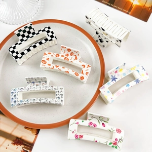 Set of six retro square claw clips with assorted patterns like checkers and pumpkins