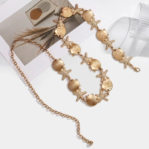 Bohemian gold waist chain with shell and starfish charms on a white background